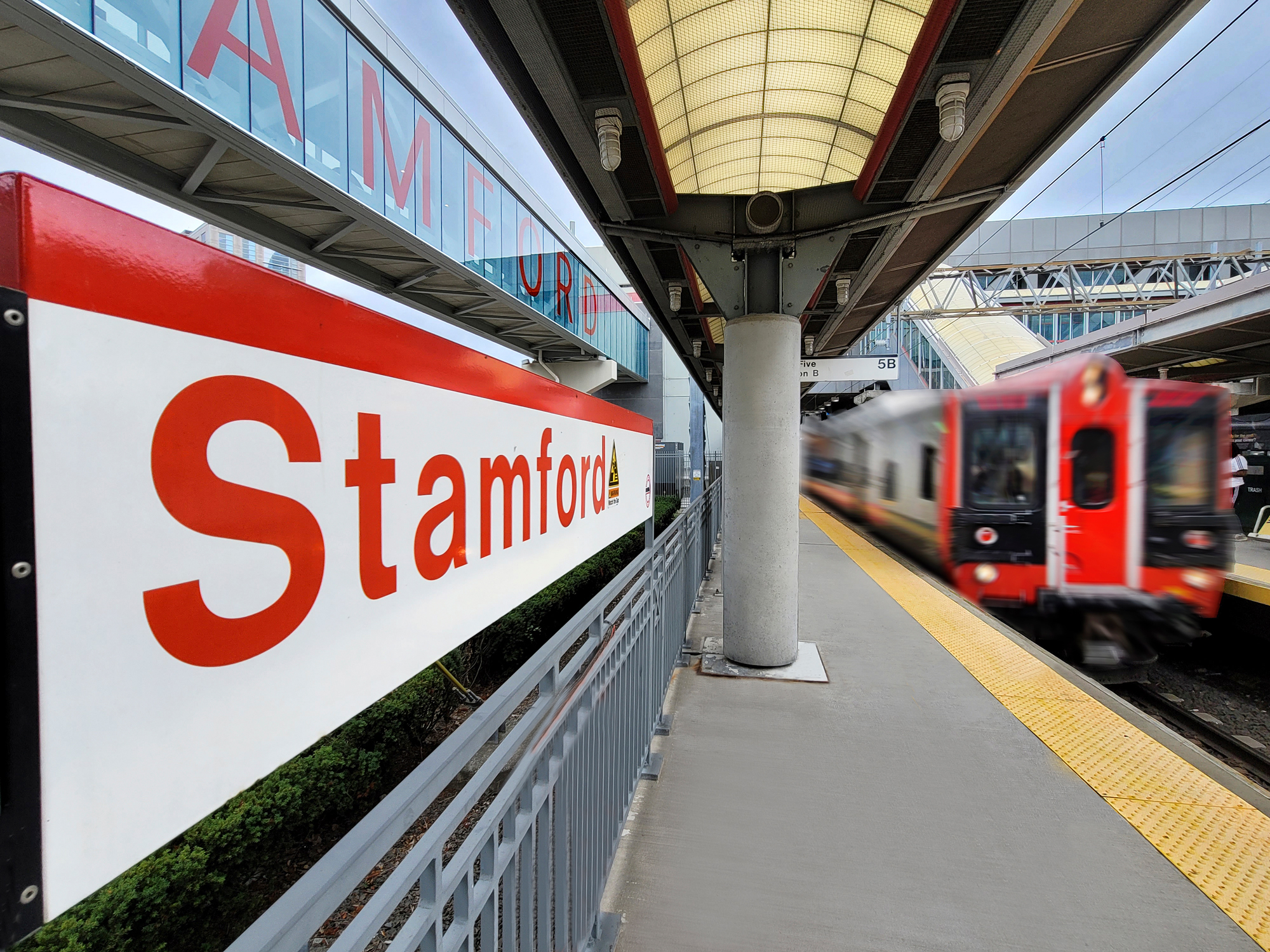 Stamford rail station with a train pulling out with motion blur.